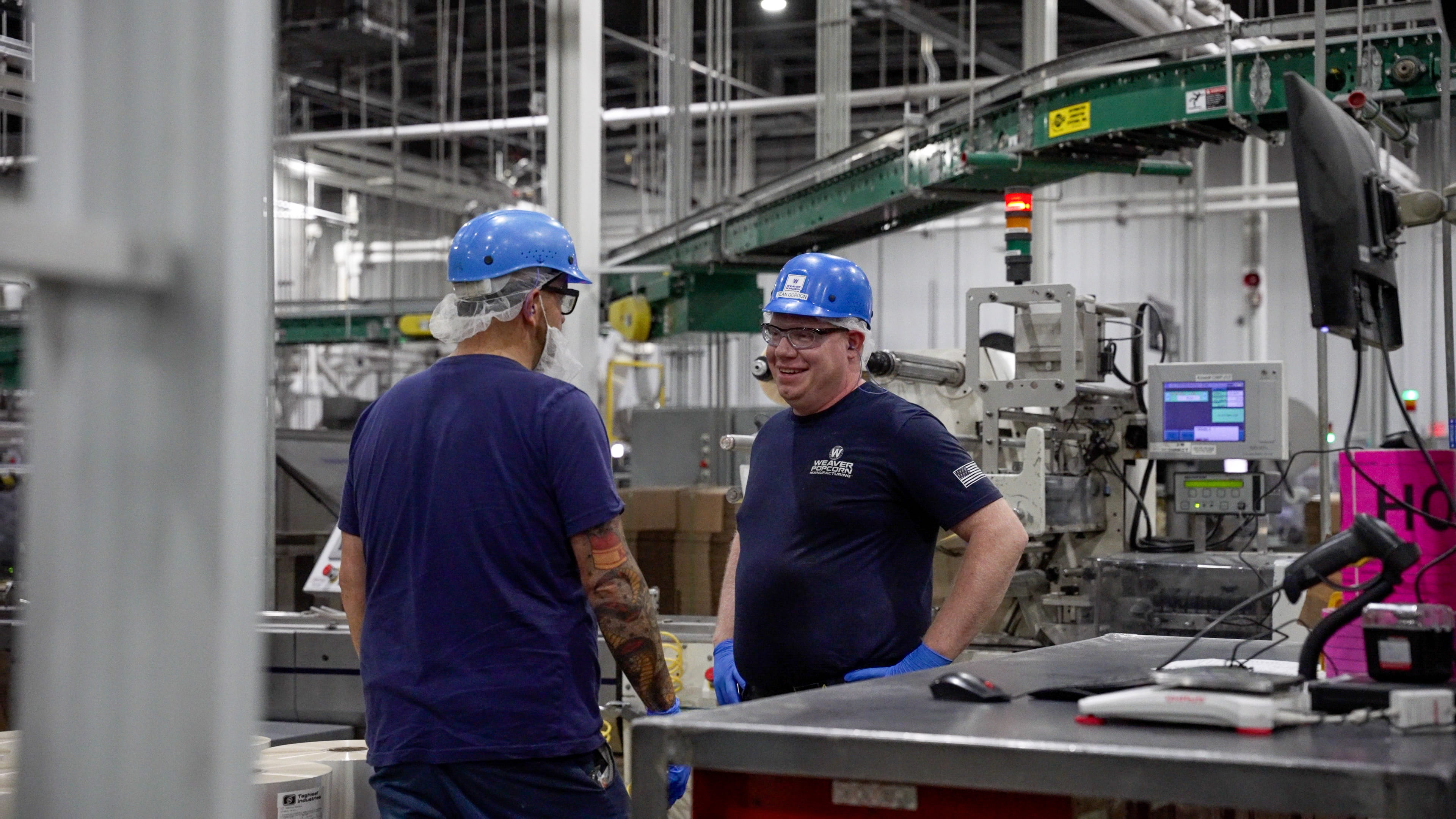 Two Male Employees Conversing During Work